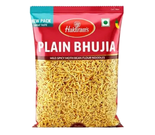 A bag of Haldiram's Plain Bhujia mild spicy moth bean flour noodles, featuring a red and teal packaging design with a clear window showing the yellow-beige noodles inside.